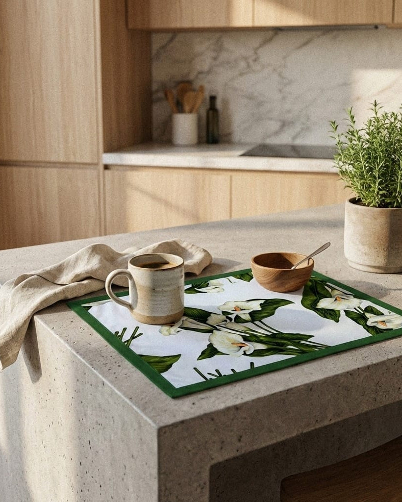 Kitchen counter with a floral placemat, mug, and bowl on a marble countertop.