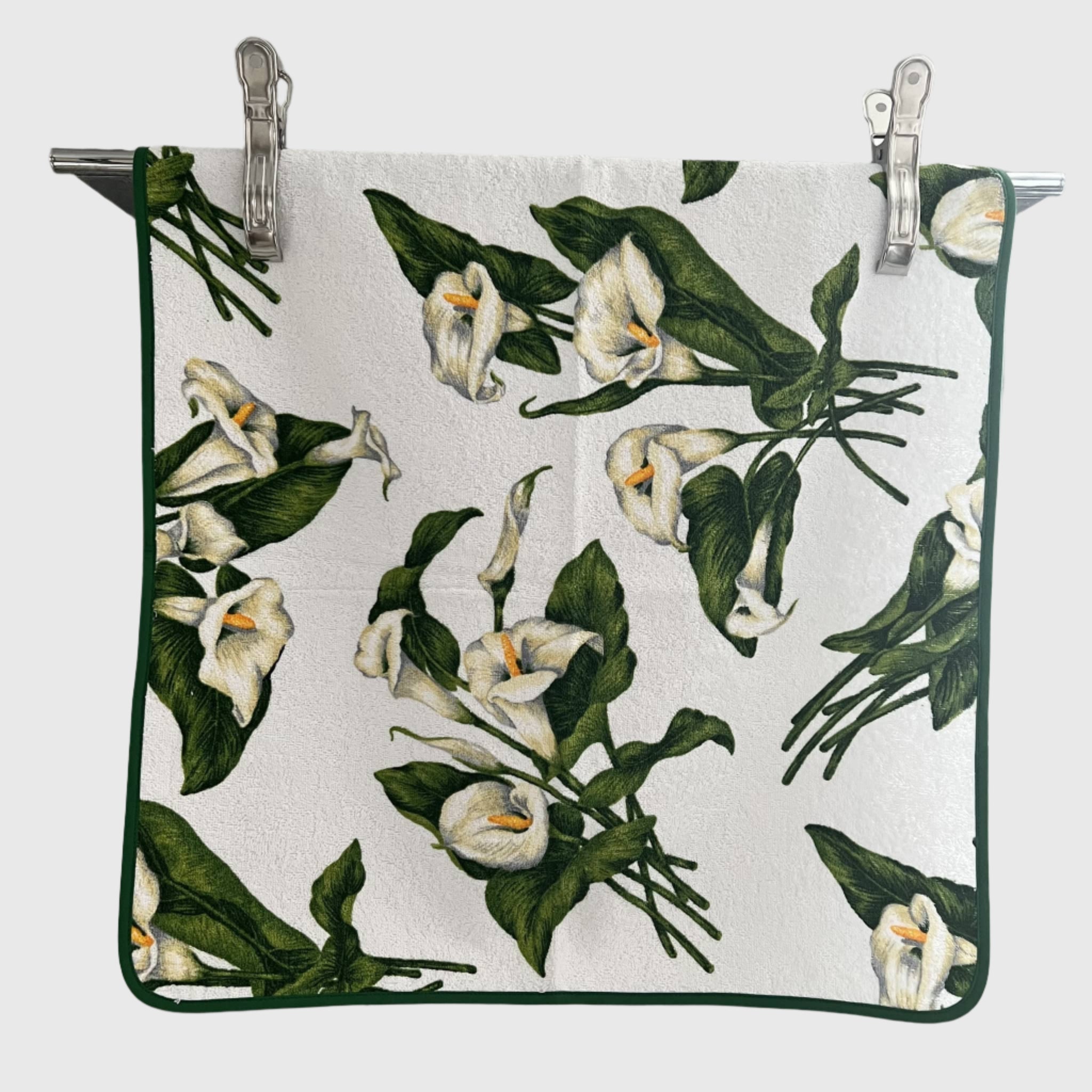 Floral patterned towel with white flowers and green leaves