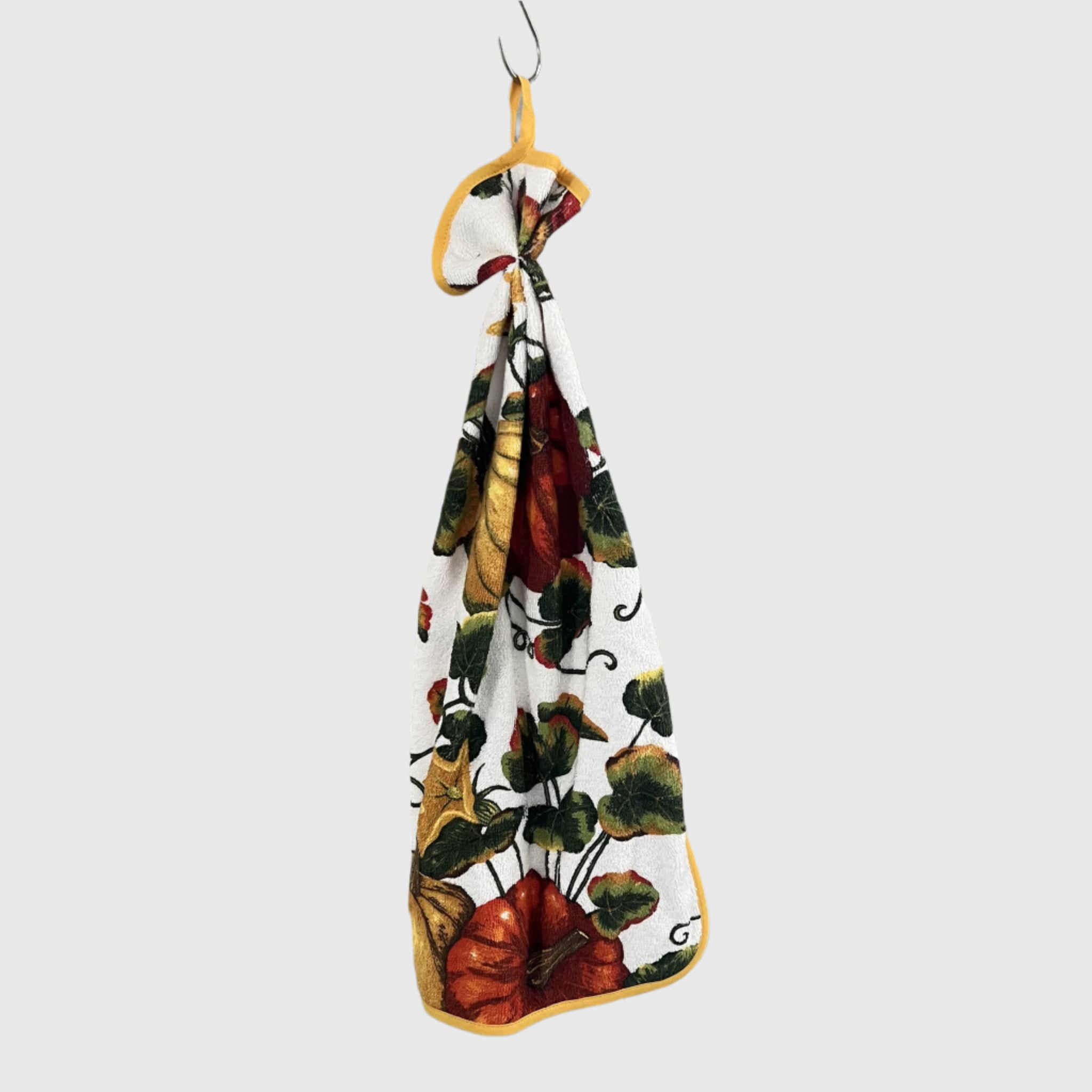 Curled towel with autumn leaf pattern featuring pumpkins